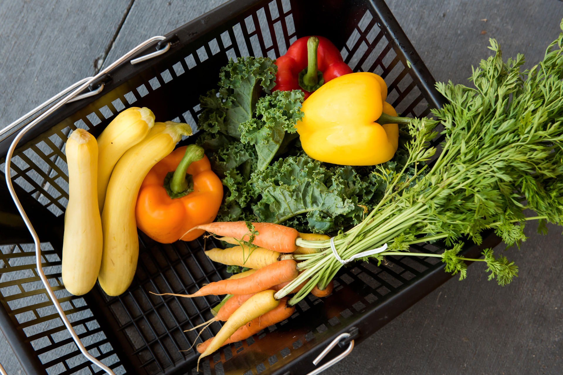 Supermarket basket containing fresh vegetables