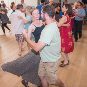 Man twirls woman on the dance floor