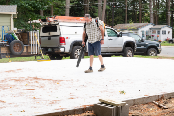 A worker prepares a site at Tanglewood Cooperative for the placement of a new home.